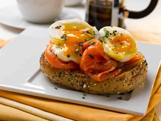 Soft boiled organic eggs and organic smoked salmon bagels