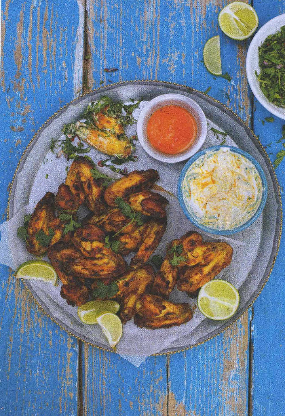 Roast chicken wings with dipping sauces and herbs