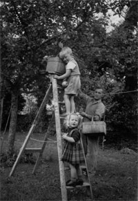 Georgina Campbell picking apples as a child on the farm with her father Brian and brother Andrew